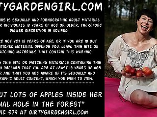 Dirtygardengirl put lots of apples inside her anal hole in the forest